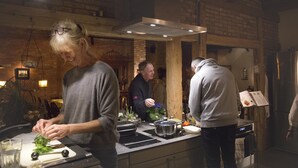 A kitchen with a brick wall, a hanging light fixture, and a stainless steel range hood. - App. Morniglight, flooded by the sun (Luhnstedt)