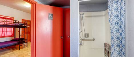 A room with bunk beds, a shower, and a door marked "accessible".