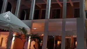 The exterior of the ARCHOTEL building with arched windows and a sign above the entrance. - Archotel (Dakar)