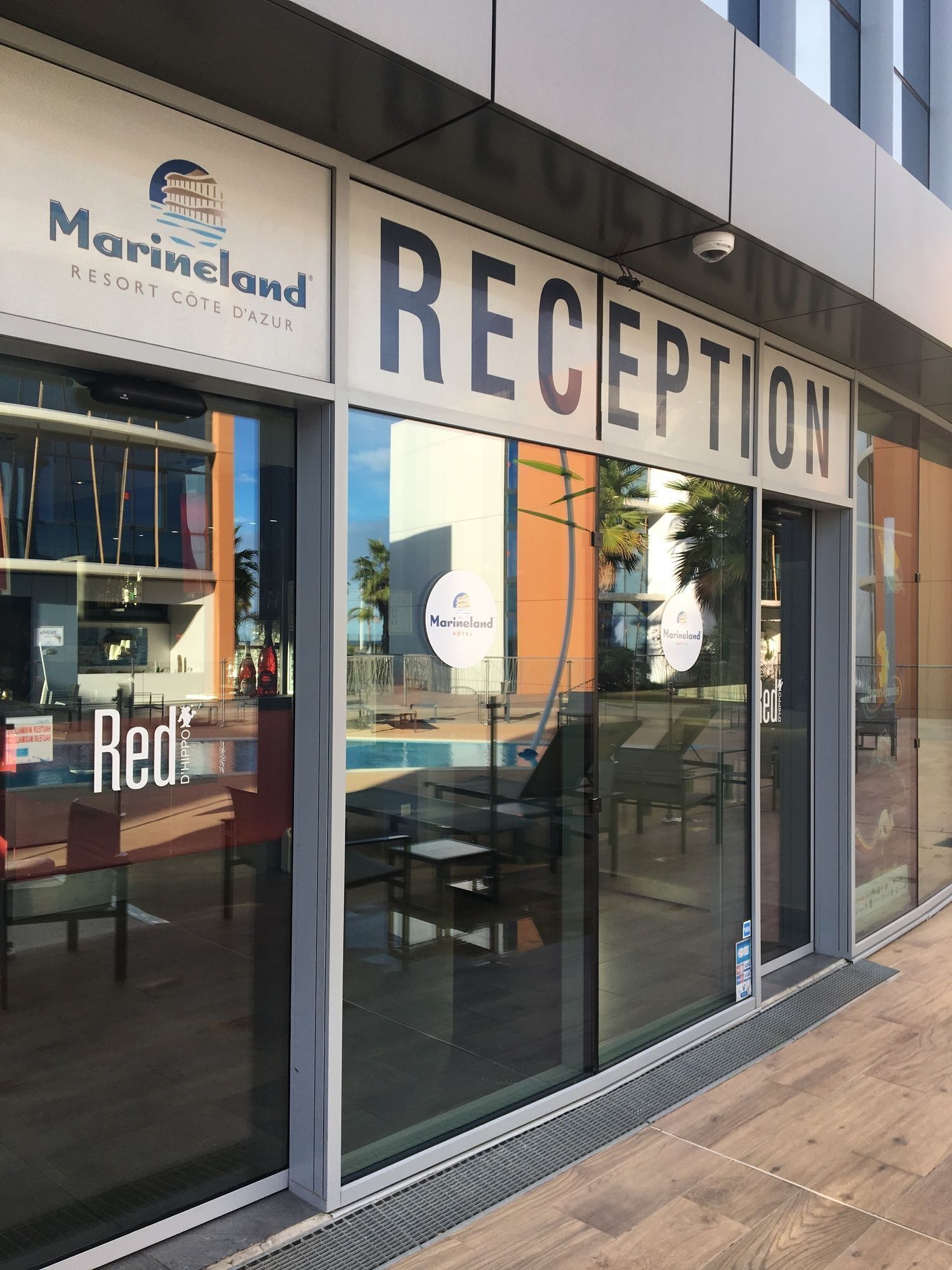 A reception area with a large sign reading "RECEPTION" and "Marineland Resort Côte d'Azur".