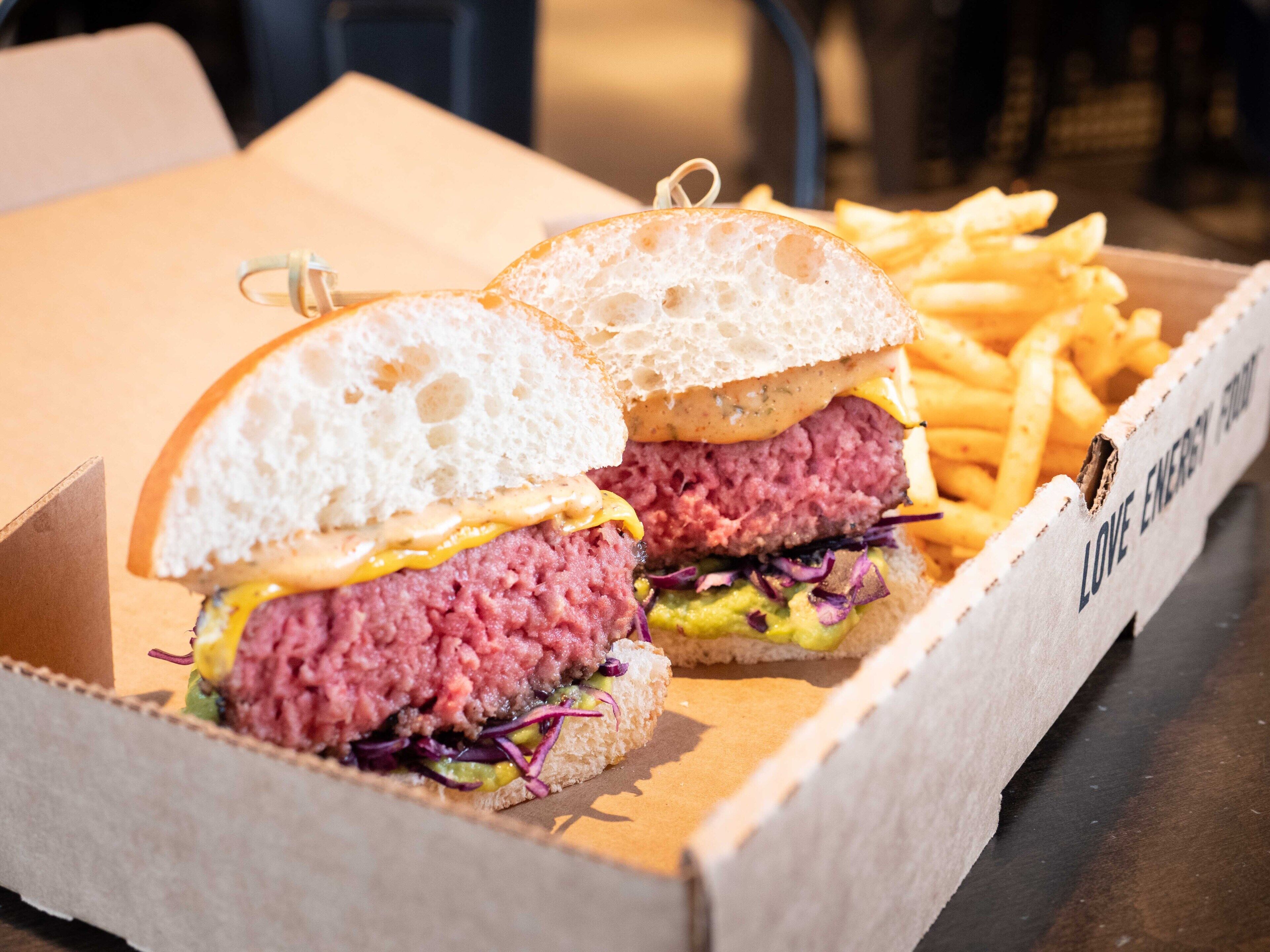 A box containing a burger and fries.
