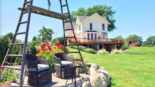 A house with a deck, outdoor furniture, and a swing set. - Country Hermitage B&B (Williamsburg)