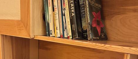 A wooden shelf with books and a carved wooden box with the text "WEN 1913".
