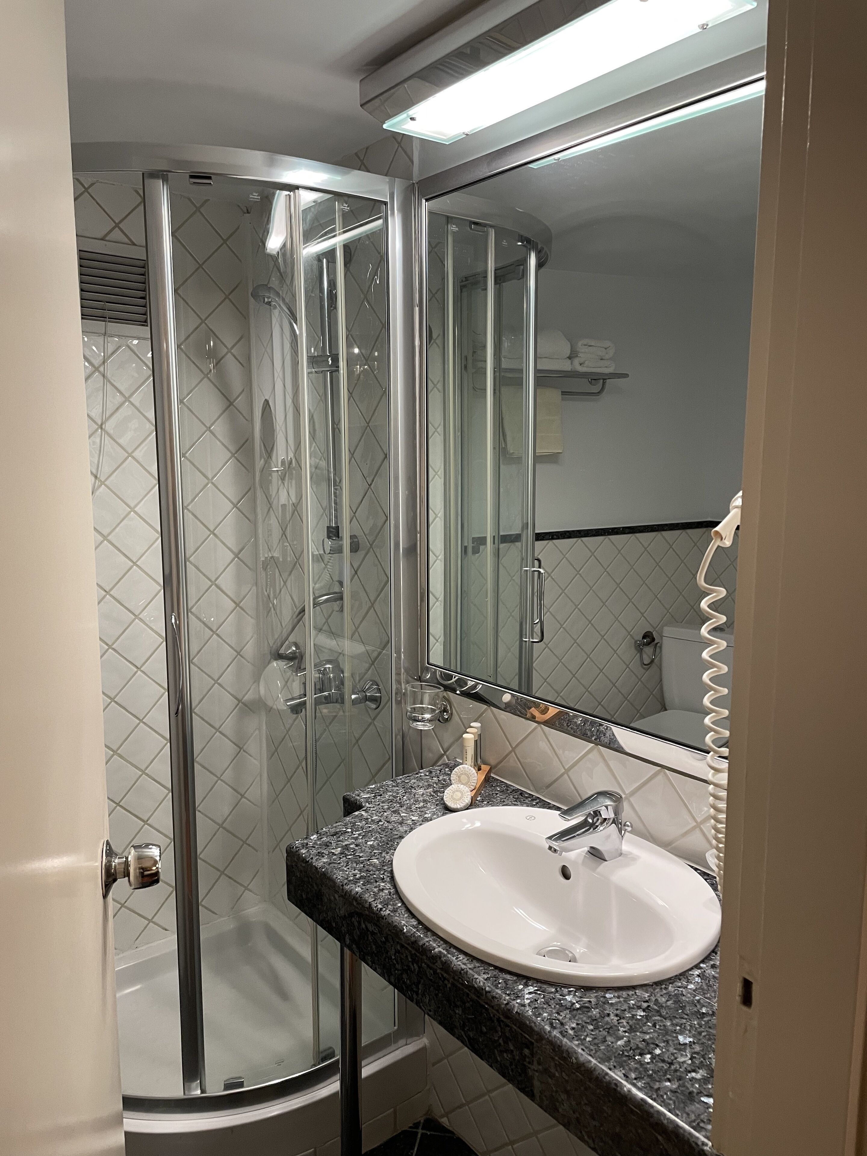 designer toiletries, hair dryer, bathrobes, slippers