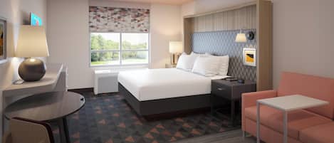 Una habitación de hotel con cama, escritorio, silla y sofá.