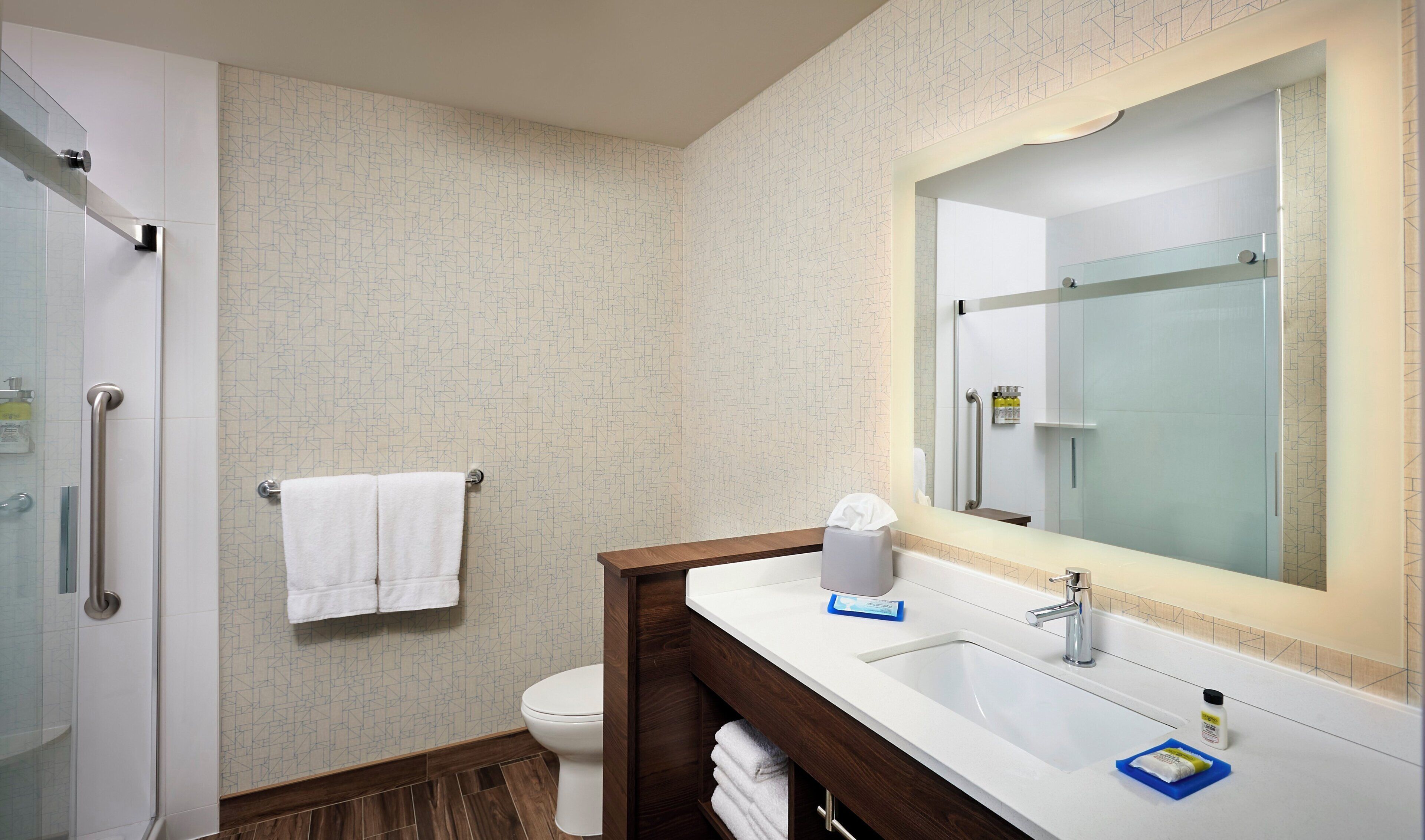 A bathroom with a shower, toilet, and sink.