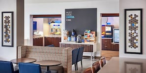 A modern hotel lobby with a coffee station, seating area, and framed artwork. - Holiday Inn Express and Suites Brantford by IHG (Brantford)