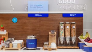 A breakfast bar with cereal and fruit options, a sign asking "FEELIN' FRESH THIS MORNING?", and a "GOOD MORNING" sign. - Holiday Inn Express and Suites Brantford by IHG (Brantford)
