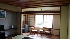 A room with tatami flooring, a television, a refrigerator, and a window with a view of greenery. - Ohamaso (Toba)