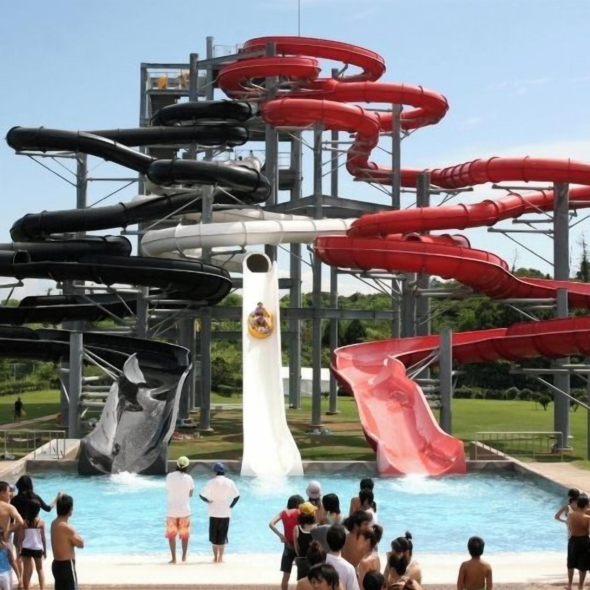 A water park with multiple water slides and a pool area.