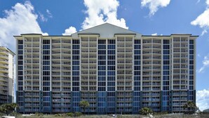 A multi-story hotel with balconies, a flat roof, and a clear sky. - New 1bd w/ OPEN DATES! Sleeps 4 (Panama City Beach)