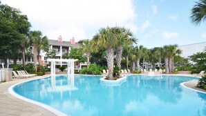 A swimming pool with lounge chairs and palm trees. - Bayside Resort ~ Large Balcony ~ Family Friendly (Miramar Beach)