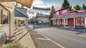 A street view with buildings, a bench, and a 'Welcome to Groveland' sign.