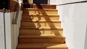 A wooden staircase leading to a door with a metal railing. - Woodsy Hideaway~Yosemite views, your getaway starts here, it's a Guest Favorite! (Groveland)