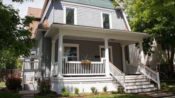 A two-story house with a front porch, a staircase, and a small garden area. - Cozy Luxury Remodel, Fantastic Backyard! Walk in 5 minutes to CSU/Old Town (Ft Collins)