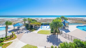 A resort with a swimming pool, beach access, and a gazebo.