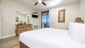 A bedroom with a bed, dresser, television, and a balcony with a view. - Relax. Recharge. Repeat 3 BR Phoenix X 1407 (Orange Beach)