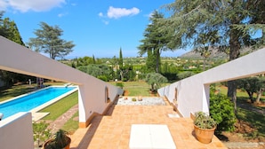 A terrace with a view of a swimming pool and landscaped garden. - Modern Villa with pool and garden Finca La Xara (Pedreguer)