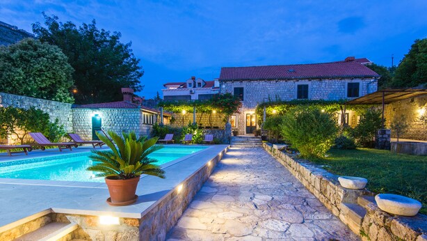 A stone pathway leading to a swimming pool with lounge chairs and a potted plant. - Property with a swimming pool, rare find within walking distance to Old Town (Dubrovnik)
