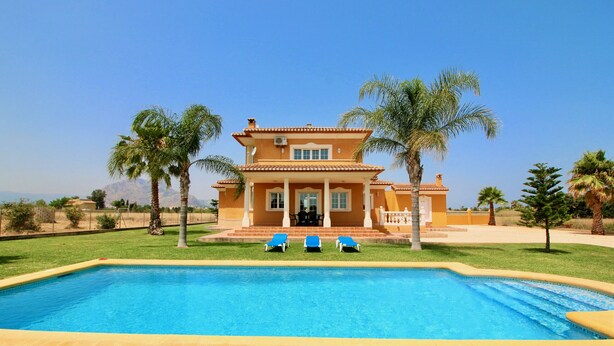 A two-story house with a swimming pool in front, surrounded by palm trees and a clear sky. - Quiet Villa with wifi and air conditioning Finca Las Ranas (Denia)