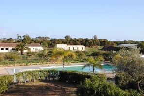 A pool area with a clear view of the surrounding landscape, including buildings and trees. - LAST MINUTE SEPTEMBER / OCTOBER (Pula)