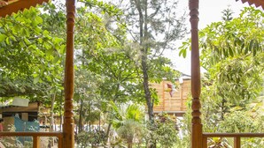 A wooden gazebo with a tiled floor and a welcome mat. - Ramsons Resort (Canacona)