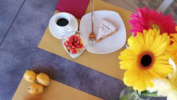A table with a variety of breakfast items including toast, jam, and a glass of orange juice.