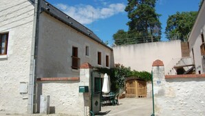 A two-story building with a white facade, a small balcony, and a green gate. - 19th Century Wine House in Loire Valley, near castles (Cangey)