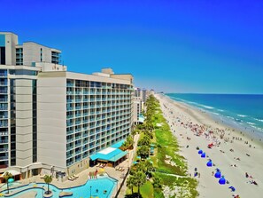 A hotel with a pool, beach access, and a view of the ocean. - 3Bd Condo in Beachside Resort w/ Amenities Galore! (Myrtle Beach)