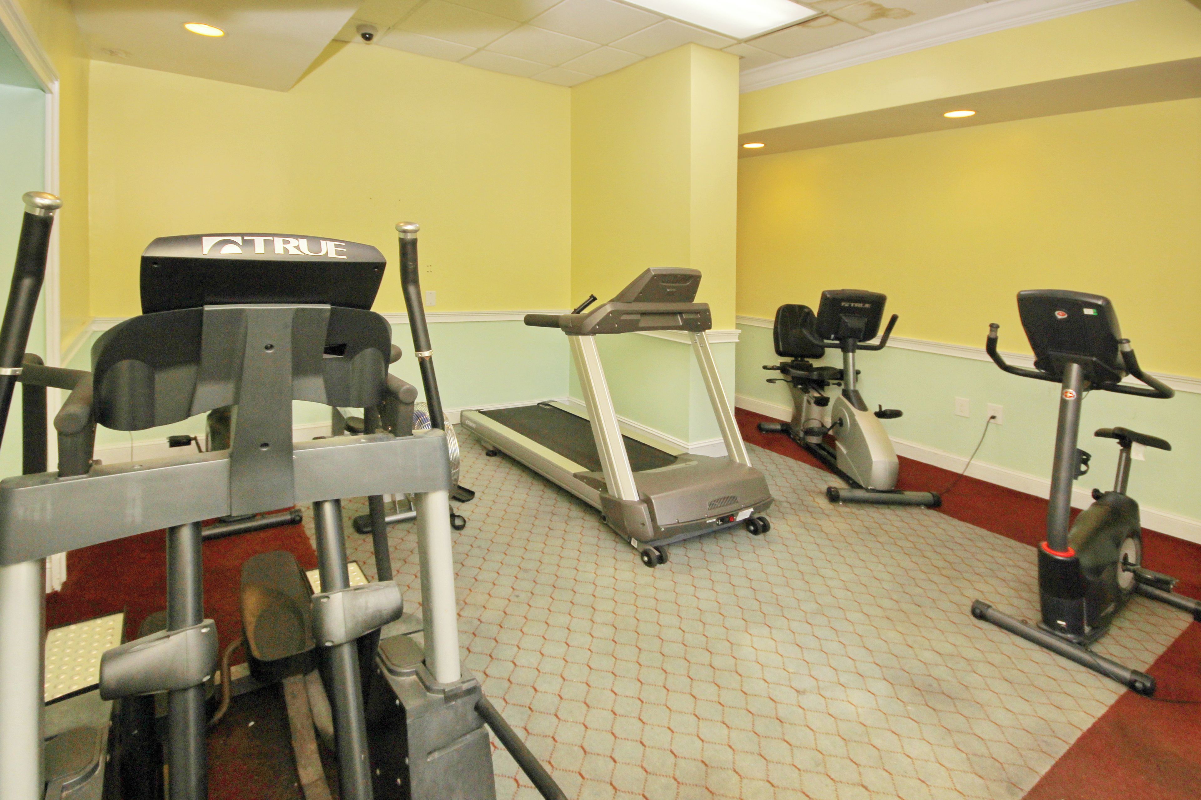 A fitness center with treadmills, elliptical machines, and weight machines.
