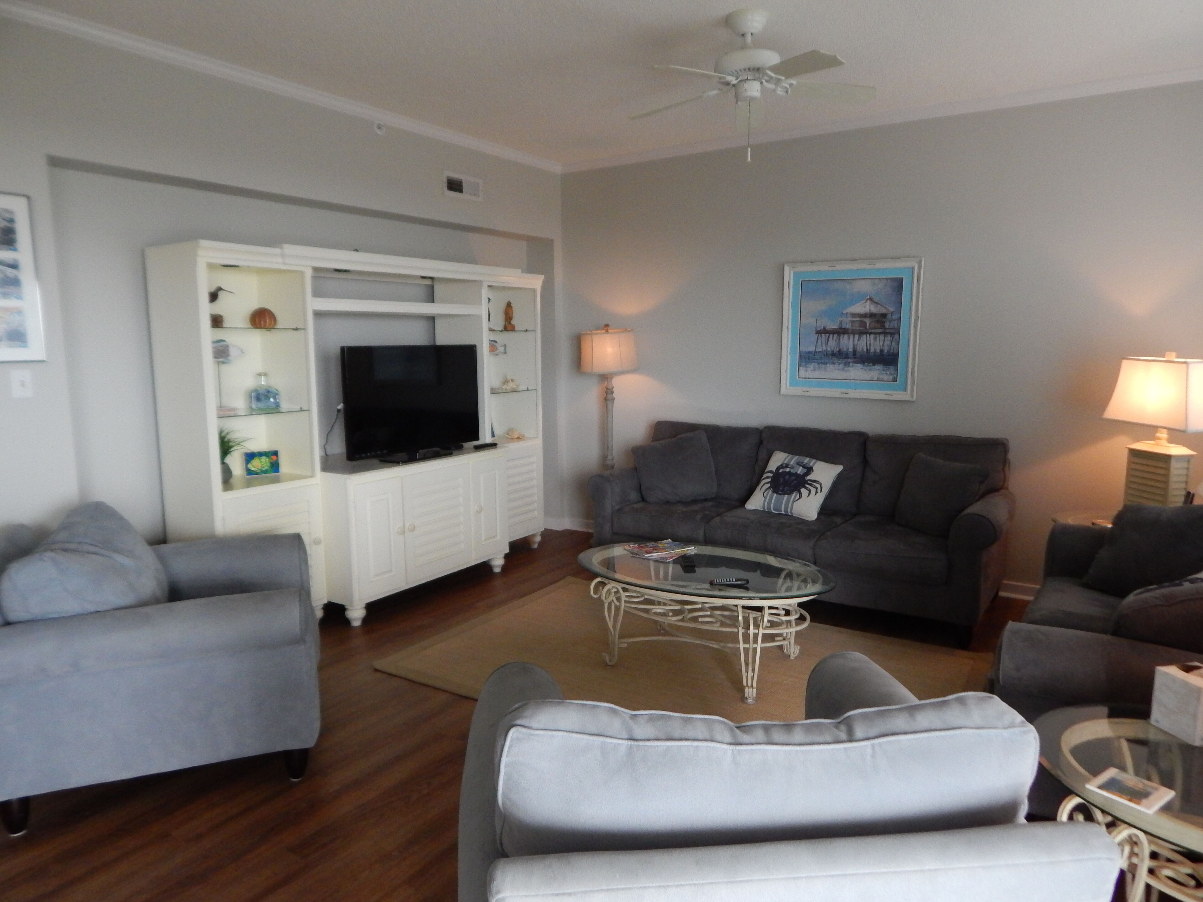 A living room with a TV, sofas, and a coffee table.