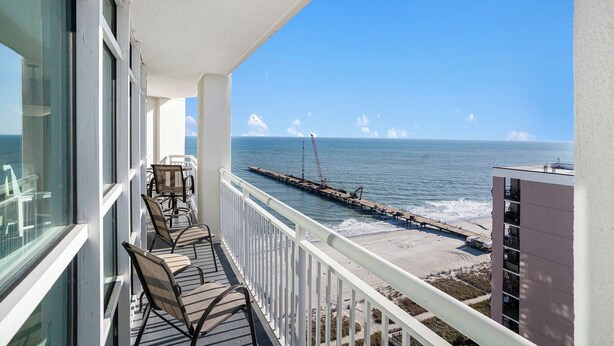 A balcony with a view of the ocean and a pier. - Amazing Views 30 ft. balcony 1 bedroom Myrtle Beach (Myrtle Beach)