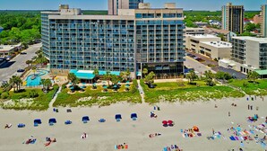 A hotel with a modern design, featuring a large building with multiple floors and balconies. - Oceanfront Condo on The Golden Mile in Myrtle Beach (Myrtle Beach)