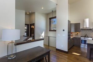 Enjoy cooking in this well-lit kitchen with an oven and range hood.