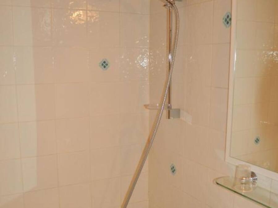 A bathroom with a bathtub, a shower, and a sink.