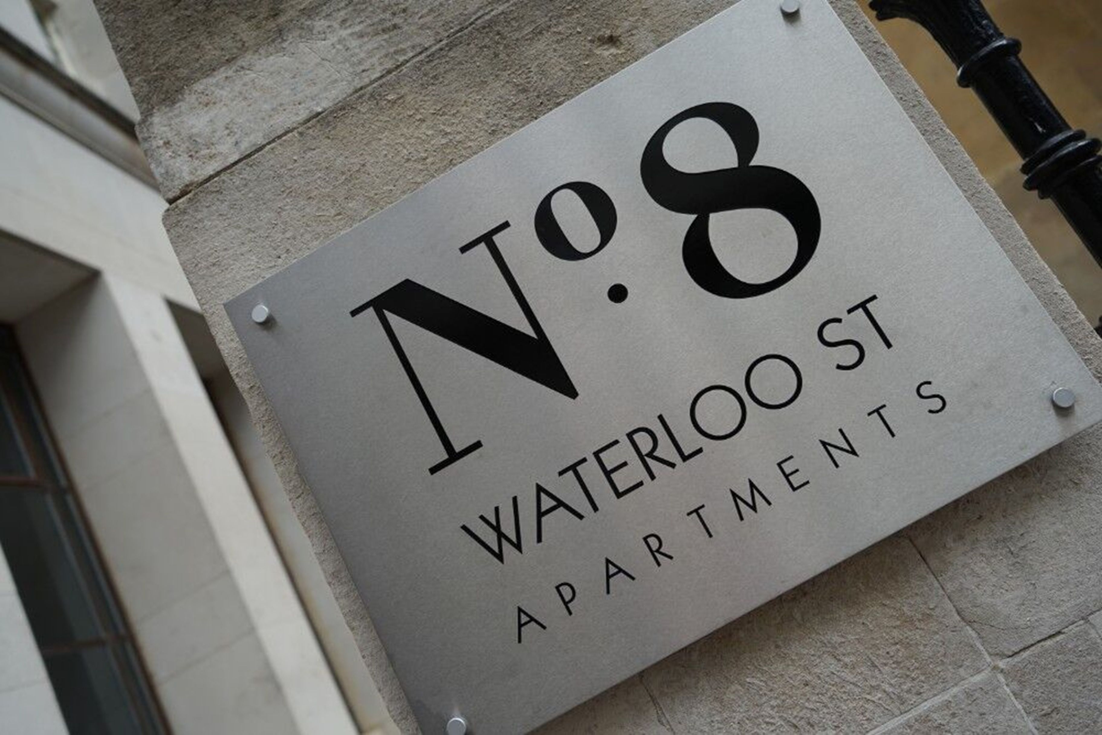 A sign for No. 8 Waterloo St Apartments.