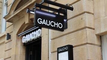 A building with a sign reading "GAUCHO" on the facade.
