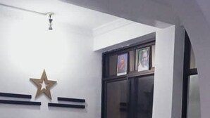 A reception desk with a star decoration, a window with pictures, and a potted plant. - Bright Star Hotel (Arusha)
