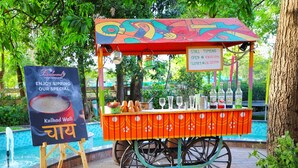 A colorful food cart with a sign advertising 'Kulhad Wali' and 'Enjoy sipping our special'. - Boulevard9, Nadiad – IHCL SeleQtions (Nadiad)