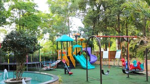A playground with slides, swings, and a small pool. - Boulevard9, Nadiad – IHCL SeleQtions (Nadiad)