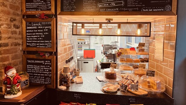 A cafe with a menu board listing items like sandwiches, drinks, and desserts. - Severn Valley Guest House (Bewdley)