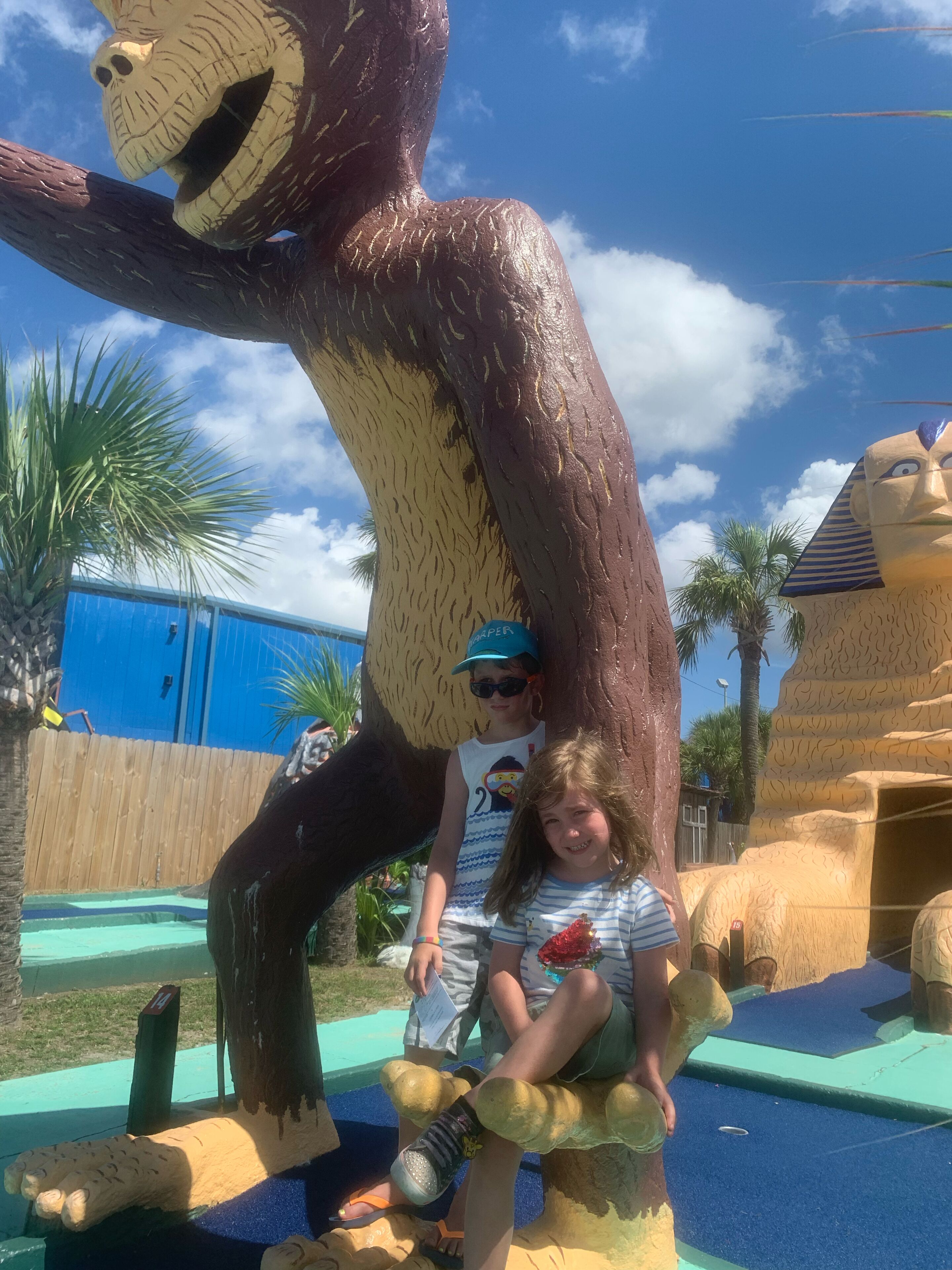 A large monkey sculpture with a child sitting on its back.