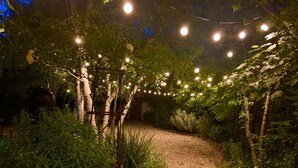 A garden pathway with string lights and trees. - Rent your own Hotel in the Victorian Goldfields (Maldon)