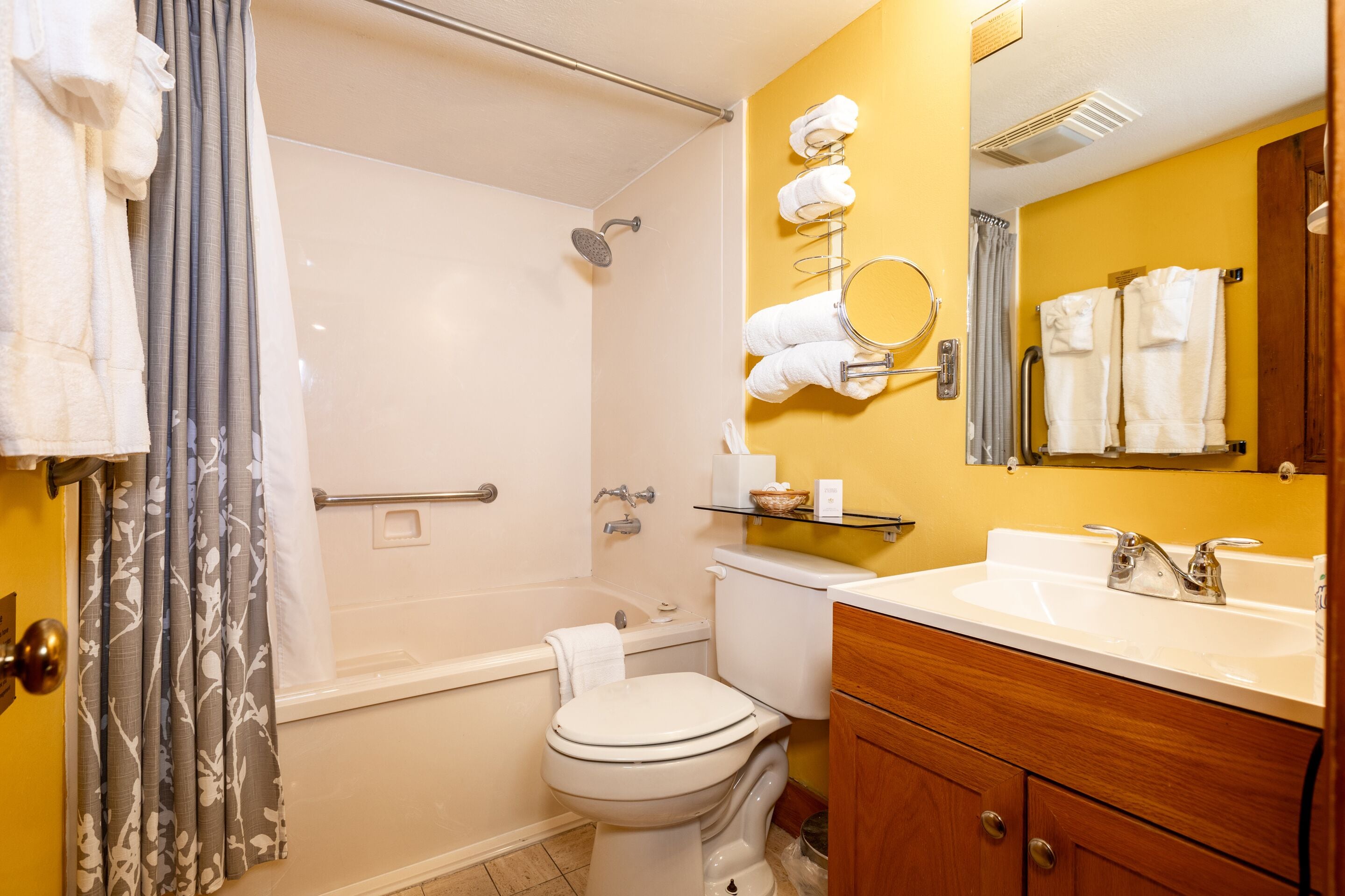 Un baño con bañera, inodoro, lavabo y espejo.