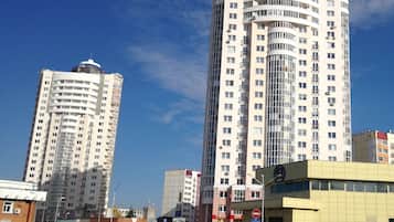Stylish high-rise building with multiple balconies and a glass facade.