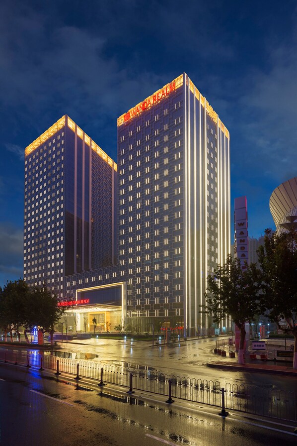 A high-rise hotel with a modern design, featuring a prominent entrance and multiple floors.