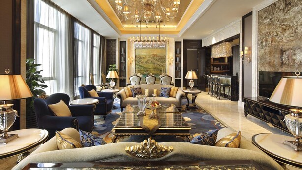 A luxurious lobby with a grand chandelier, plush seating, and a large painting on the wall. - Wanda Vista Xining (Xining)