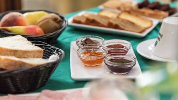 A breakfast buffet with various food items and condiments.