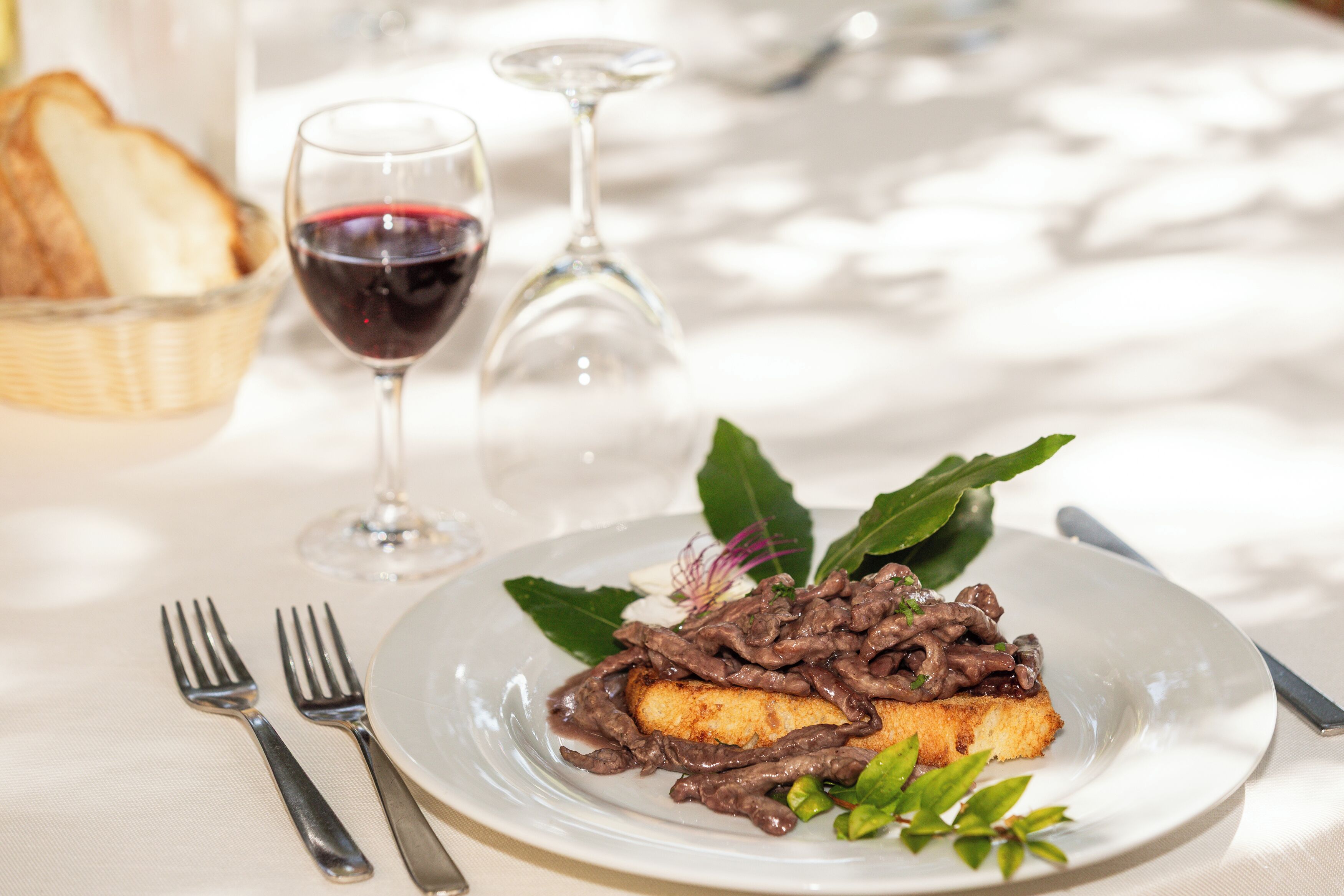 A plate of food with a fork and knife on a table.