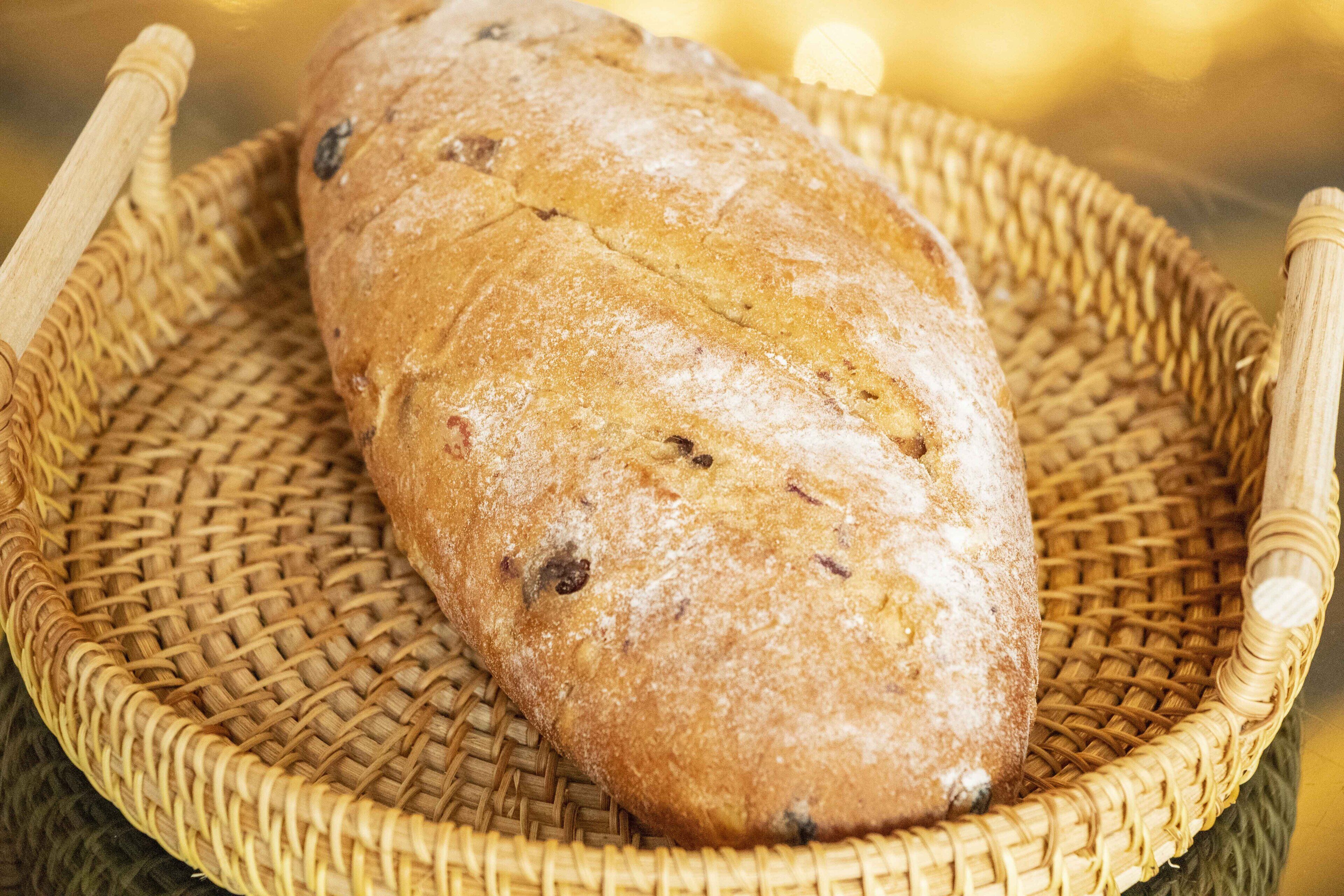 A loaf of bread on a woven basket.